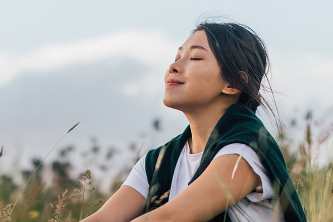 Woman sitting in field